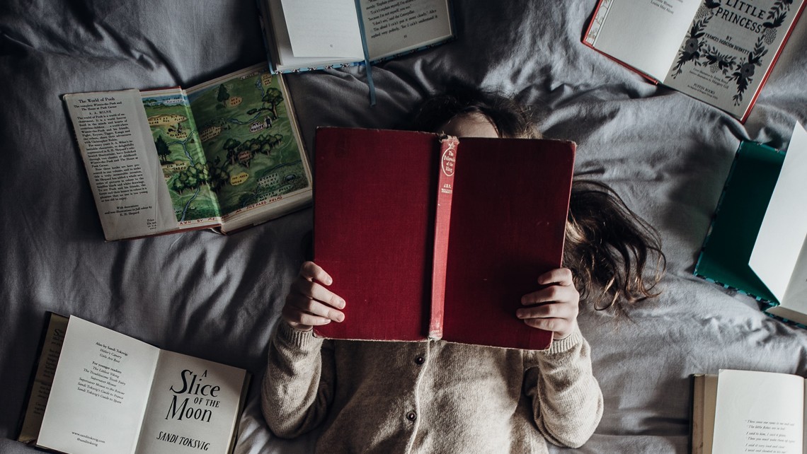 Books spread on bed | BetterBond